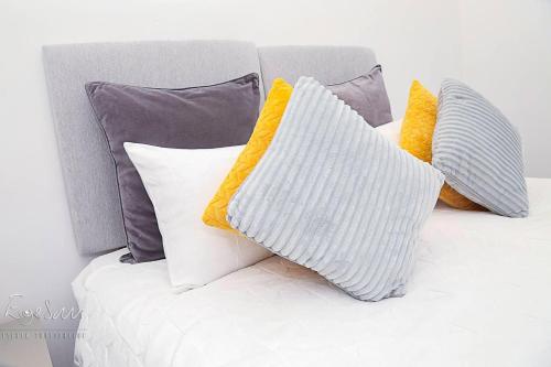 a bunch of pillows sitting on a couch at Inviting 3-Bed Apartment in Bromley in Bromley