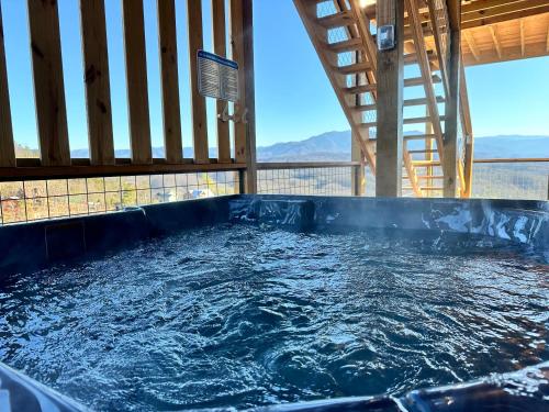 a jacuzzi tub with a view of the mountains at 7 BEARS Stunning views in Sevierville