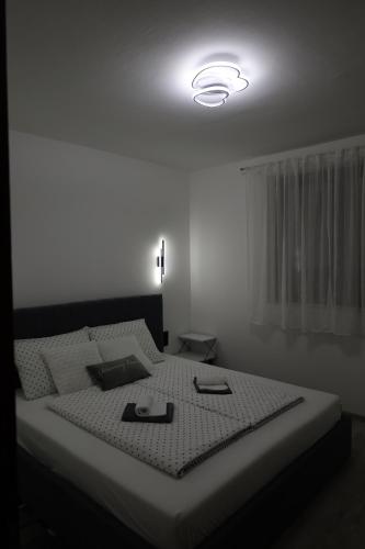 a bedroom with a large bed with a light on it at Hacijenda in Vukovar