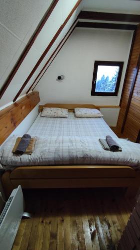 a bed in the attic of a house at Zlatni Hrast in Pale