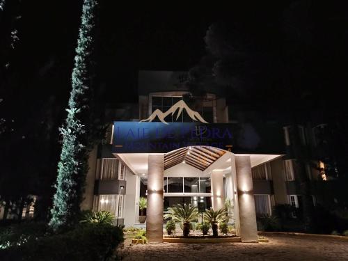 a hotel at night with a sign that reads neueldelde bermondsey at Laje de Pedra Mountain VillagePrime in Canela