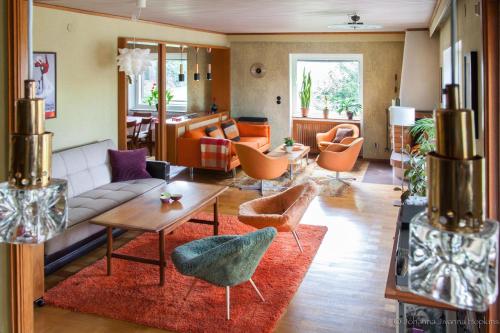 a living room with a couch and a table and chairs at Villa Berkle in Stockholm