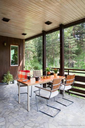 a patio with a wooden table and chairs at Villa Berkle in Stockholm
