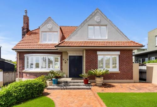 a home with a brick house at Sky Stars Elegant Home with Seaview in Auckland