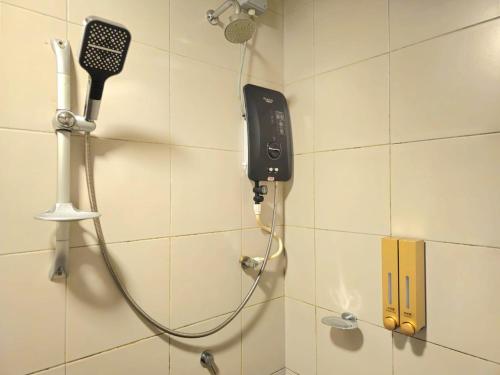 a phone on the wall of a shower in a bathroom at Meridian Medini 2 双单床舒适环境齐全设备 in Nusajaya