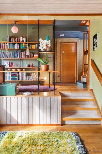a room with a staircase with a book shelf at Villa Berkle in Stockholm