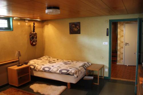 a bedroom with a bed and a table in it at Villa Berkle in Stockholm