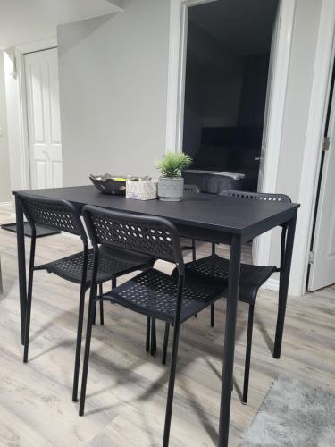 a black dining room table and chairs with a table at Covenant Properties in Edmonton