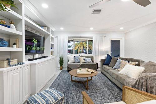 a living room with a couch and a table at Newly renovated 3 bedrooms near the beach and res1 in Pompano Beach