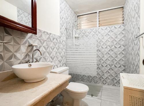 a bathroom with a sink and a toilet at Nice Central Studio Apartment in Santo Domingo