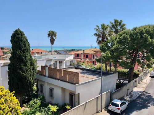 a white car parked in front of a house at Casa Lilly in Porto SantʼElpidio