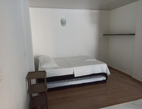a bedroom with a bed in a white room at El santorini colombiano en Doradal in Puerto Triunfo