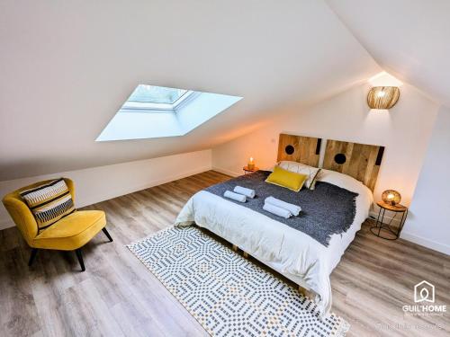 a attic bedroom with a bed and a skylight at Terrasse et Jardin * Calme * Central * Local vélo in Orléans