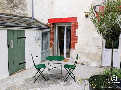 une table et des chaises devant un bâtiment dans l'établissement Terrasse végétalisée - Climatisation - Local vélo - Parking gratuit dans la rue, à Orléans