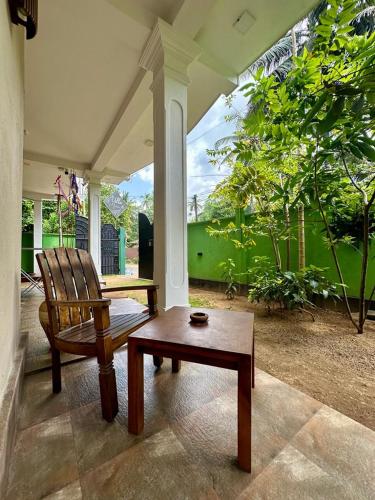 a living room with a chair and a coffee table at Siyon Yula - Guest House in Hikkaduwa