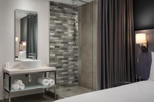 a bathroom with a sink and a shower at Protea Hotel Fire & Ice by Marriott Cape Town in Cape Town
