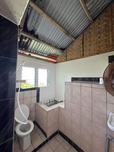 a bathroom with a toilet and a sink at Liberty's Lodge and Diving - Apo Island in Dumaguete