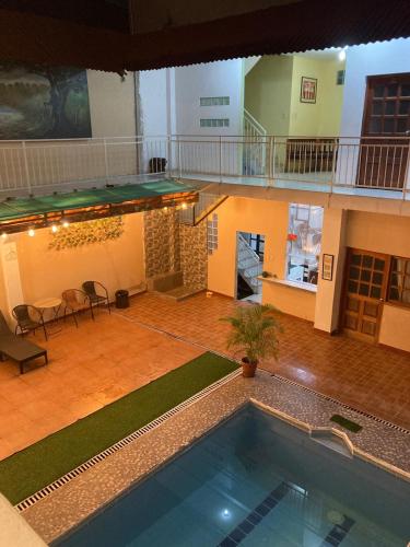 a swimming pool in a large building with a building at IGUANA HAUS IQUITOS in Iquitos