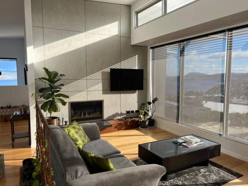 a living room with a couch and a fireplace at Fusion House in Tranmere