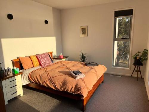 a bedroom with a large bed and a window at Fusion House in Tranmere