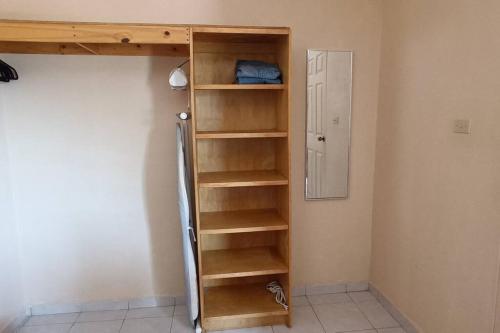 a wooden book shelf in a room with a door at Loft Flor de Pitaya in Cabo San Lucas