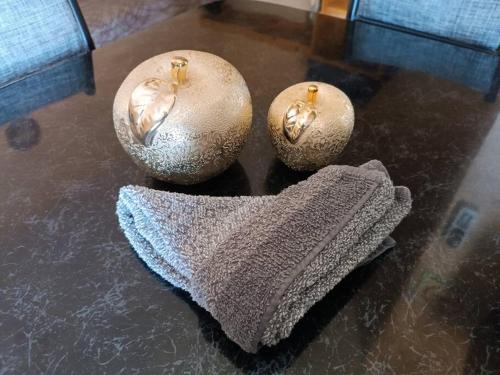 two vases and a towel on a table at Loft Flor de Pitaya in Cabo San Lucas
