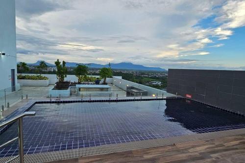 a swimming pool on the roof of a building at Best Friend Homestay in Kuching
