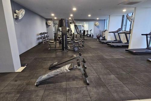 a gym with a bunch of treadmills and machines at Best Friend Homestay in Kuching