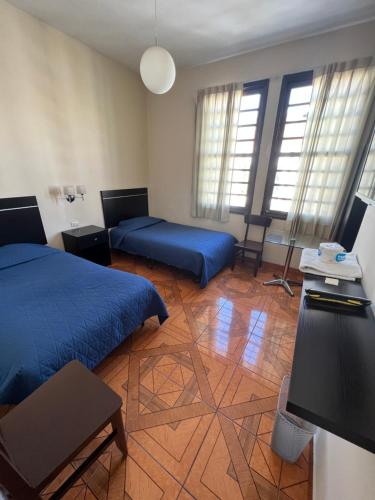 Letto o letti in una camera di Hotel Tito