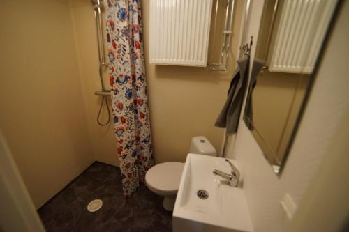 a small bathroom with a toilet and a sink at House close to the Sea in Sundsvall