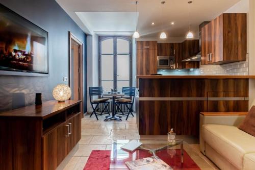 a living room with a couch and a table at Mont Blanc - Emplacement n1 au centre d'Annecy in Annecy