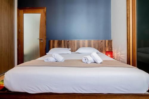 a bedroom with a large bed with two towels on it at Mont Blanc - Emplacement n1 au centre d'Annecy in Annecy