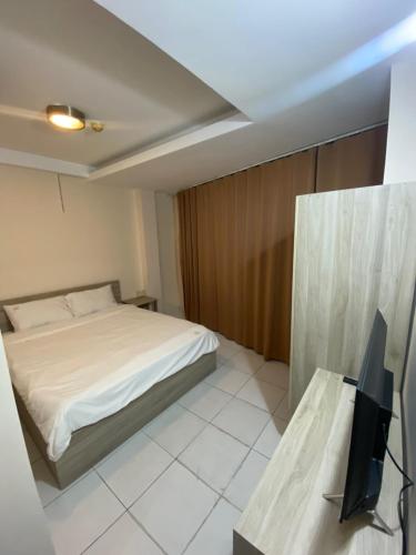a bedroom with a bed and a television in it at Liva in Ho Chi Minh City
