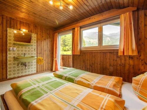 a bedroom with two beds and a shower at Resinger in Matrei in Osttirol