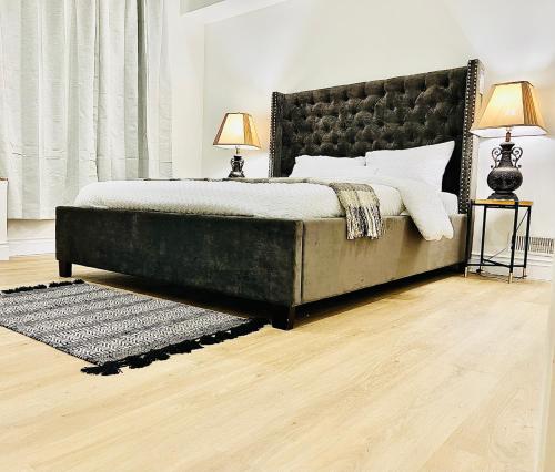a bedroom with a large bed with a black headboard at LaVida Exclusive Guest House, Free Parking (Rm#2) in London