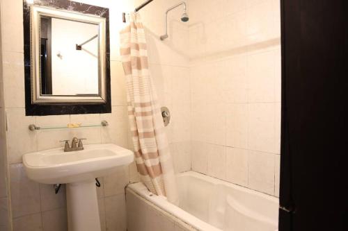 a bathroom with a sink and a mirror and a tub and a sink at Beach apt, 2 bedrooms, 2 min Plaza la Isla - Mar312 - in Cancún