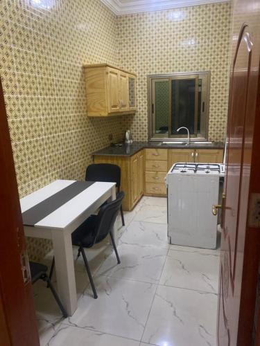 uma cozinha com uma mesa, um lavatório e uma máquina de lavar louça em Two bedroom apartment Paradise estate Apt em Bureng