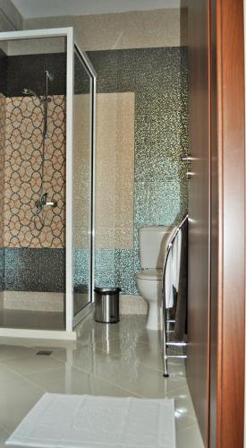 a bathroom with a toilet and a glass shower at Vikeya Guest House in Sapareva Banya