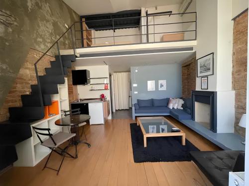 a living room with a blue couch and a staircase at Rooms Galata in Istanbul