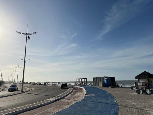 a road next to the beach with cars parked at VILA LITORANEA Hotel in São Luís