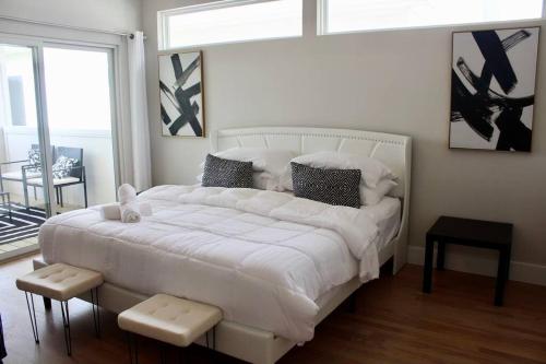 a large white bed in a room with a window at Chic City Oasis • King Suite 3BR/2.5BA• Near Downtown & NRG in Houston