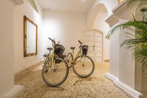 two bikes parked next to each other in a hallway at Hotel Casa del Gobernador in Cartagena de Indias