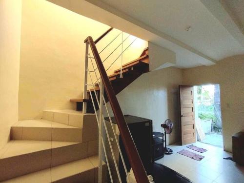 a staircase in a living room with a stair case at Town House Good for Family Stay in General Trias