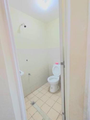 a bathroom with a white toilet and a sink at Town House Good for Family Stay in General Trias