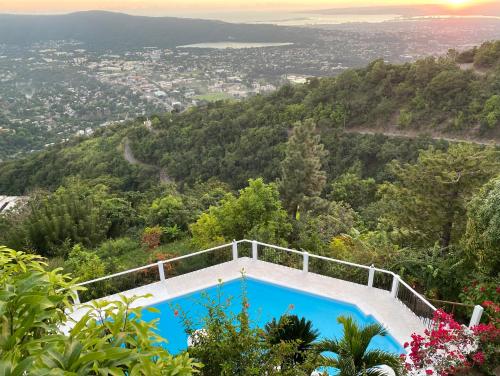 a swimming pool on top of a hill with a view at Tranquility Estate in Kingston