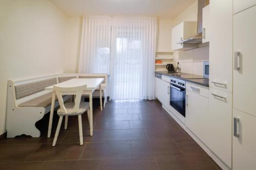 a kitchen with a table and a table and chairs at Smile Apartment in Tiddische