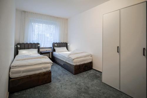 a bedroom with two beds and a window at Smile Apartment in Tiddische