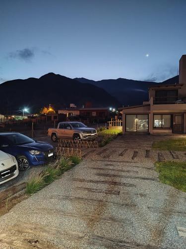 a parking lot with cars parked in front of a house at Möller Masi in Purmamarca