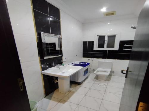 a bathroom with a sink and a toilet at ريستو للشقق المخدومة in Jeddah