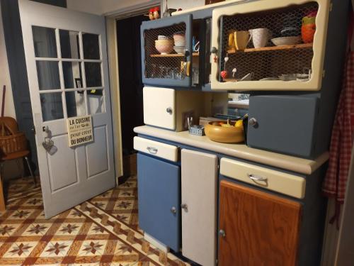 a kitchen with an open cabinet and a door at Authentic Mas 265 m2 in Plan-dʼOrgon